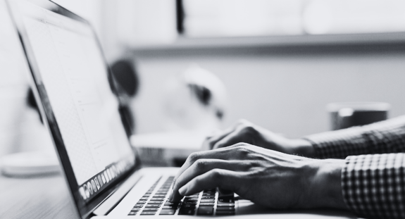 person typing on laptop